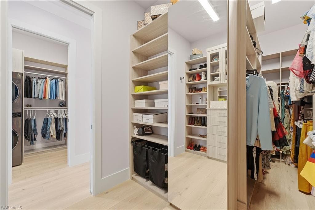 The second-level primary suite is complemented by expansive walk-in closets and the exceptional convenience of a full-size, stacked washer and dryer, creating a private retreat that combines refined luxury with effortless everyday living.