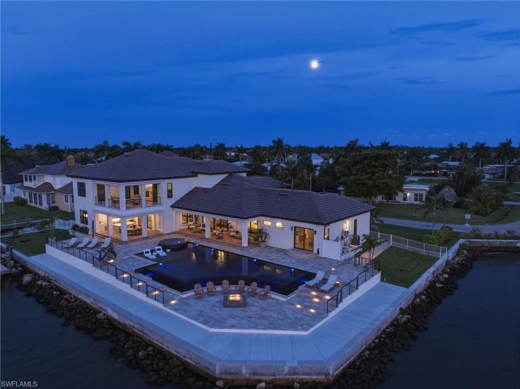 More than 8,100 square feet of beautifully pavered outdoor living space unfolds around the estate, complemented by an expansive wraparound captain’s walk that enhances both waterfront access and the exceptional scale of this private coastal retreat.