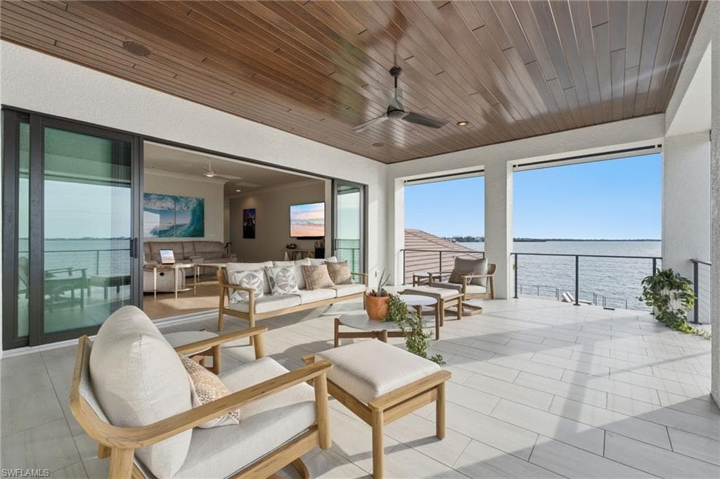 This private balcony is conveniently accessed from both the primary suite and the upstairs living room, offering a seamless transition to the breathtaking waterfront setting.