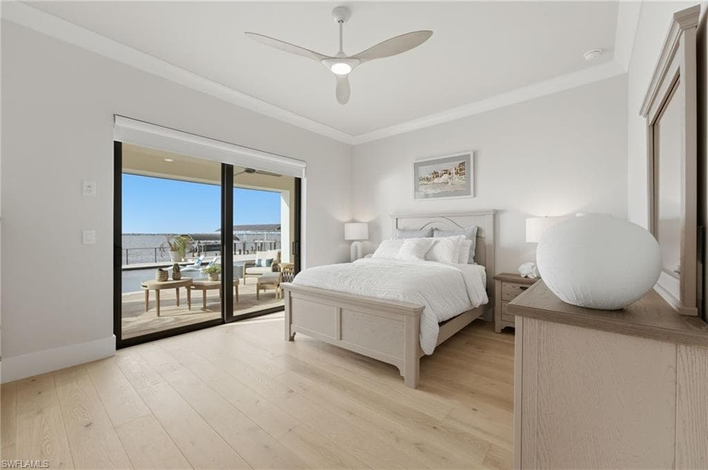 The second bedroom is privately positioned on the main level, offering seamless access to the pool and expansive lanai through sliding glass doors. Every bedroom within this exceptional residence captures a captivating water view, creating a tranquil connection to the waterfront from every private retreat.