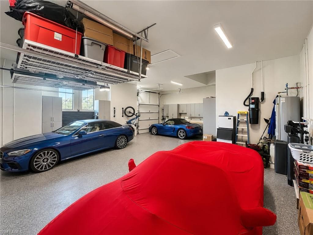 The air-conditioned four-car garage offers exceptional flexibility, with ample space to accommodate up to eight vehicles by adding electric lifts. Currently, the garage features innovative automated storage shelving that raises and lowers at the touch of a button, providing effortless organization while preserving valuable space.