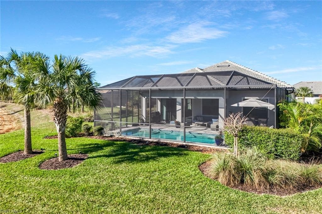 Screened-in pool area featuring a tile roofline, stucco exterior, and sliding glass doors