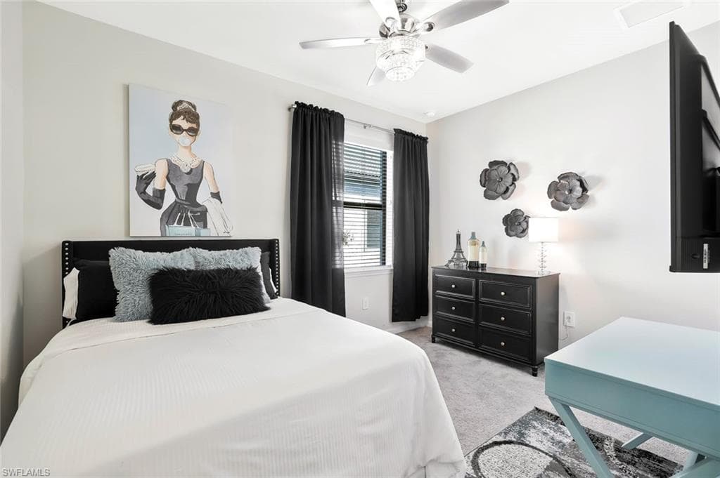 Bedroom featuring light gray wall paint, a ceiling fan with integrated lighting, window with horizontal blinds, and carpeting