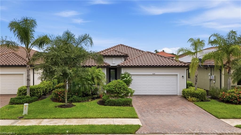 Contemporary single-story residence featuring a tile roof and light-toned exterior siding