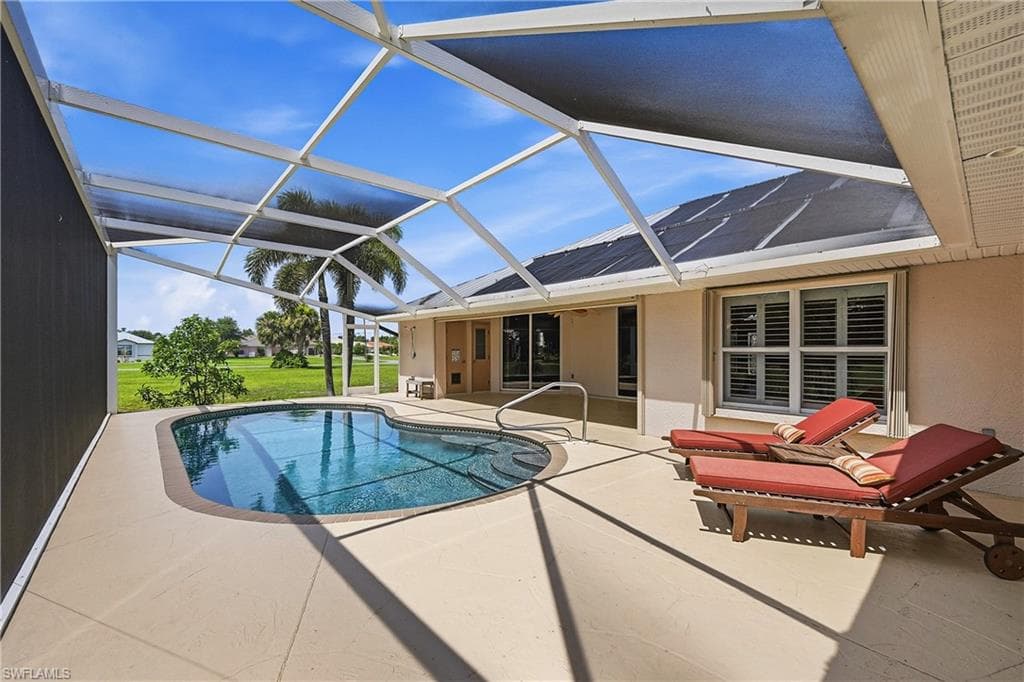 Screened lanai with a resort-style swimming pool featuring concrete decking, and expansive lounge area for sunning