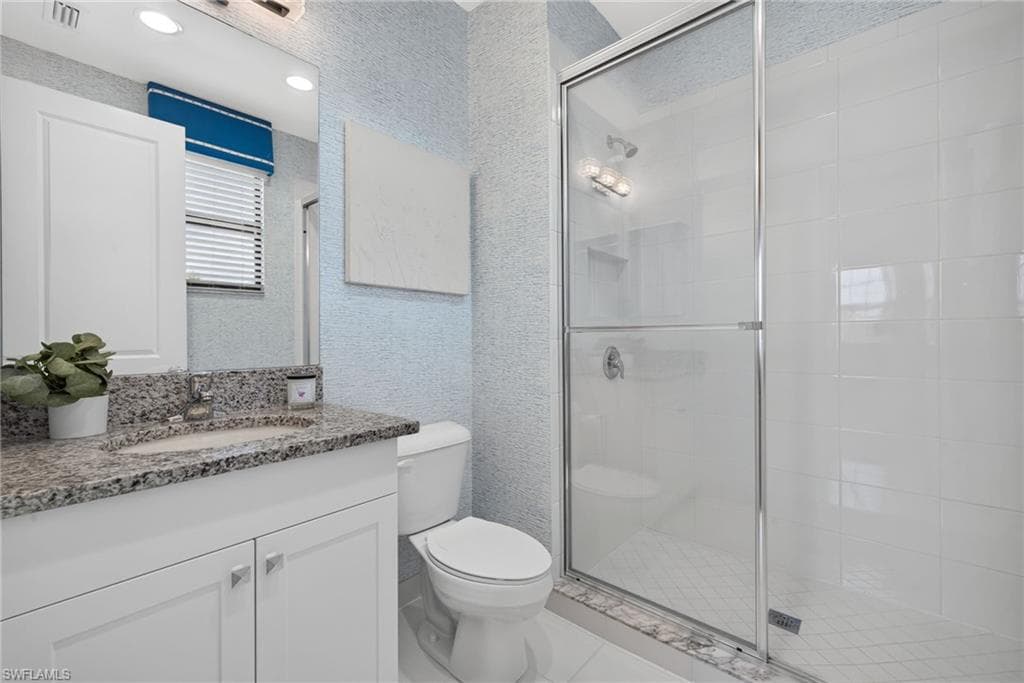 4th bathroom, ensuite. White vanity with granite countertop, integrated sink, and chrome faucet, wall paper finish