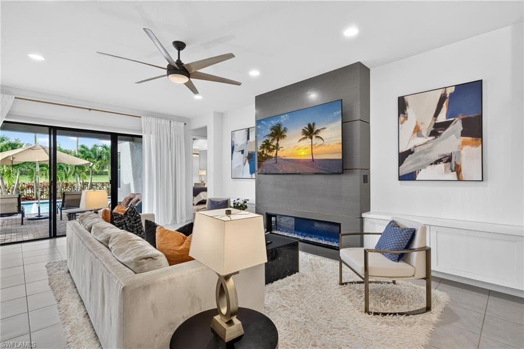 Recessed lighting, ceiling fan, built-in electric fireplace, and tiled flooring