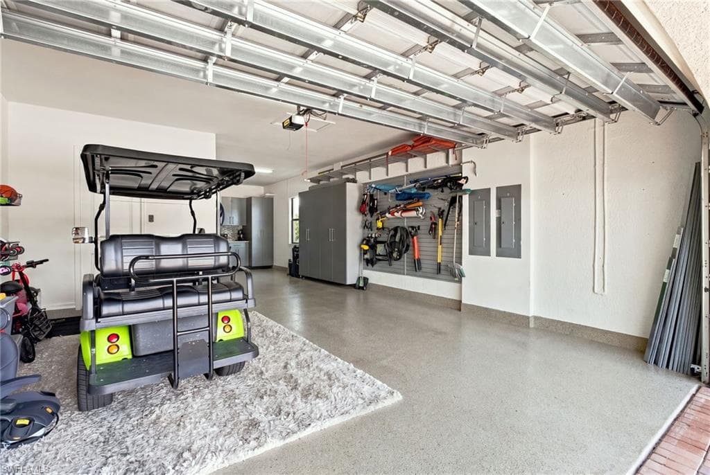 Epoxy-coated 3 car tandem garage with built-in wall organization, overhead garage door opener, and steel storage cabinets
