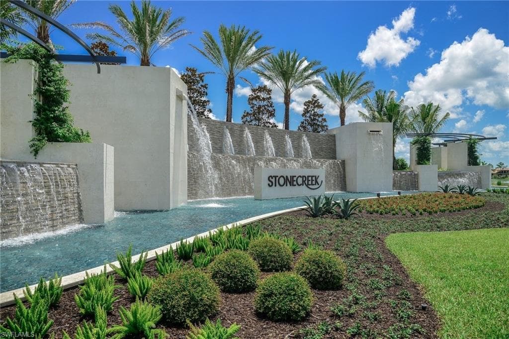 Grand community entrance with manned security gate.