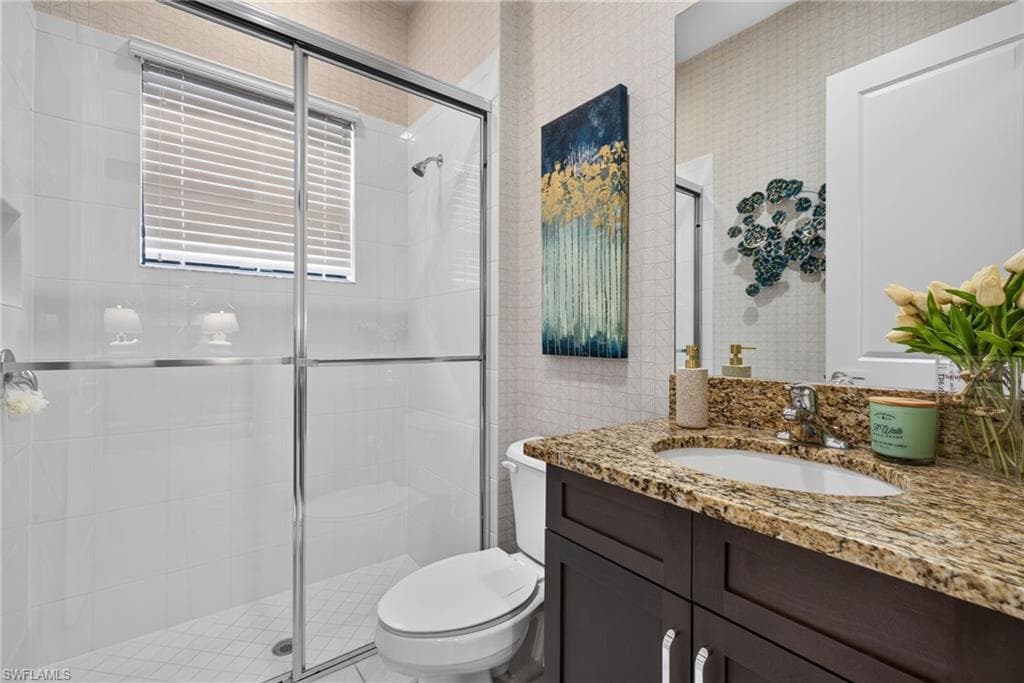2nd bathroom (1st floor). Shower with clear glass enclosure and white tiled walls