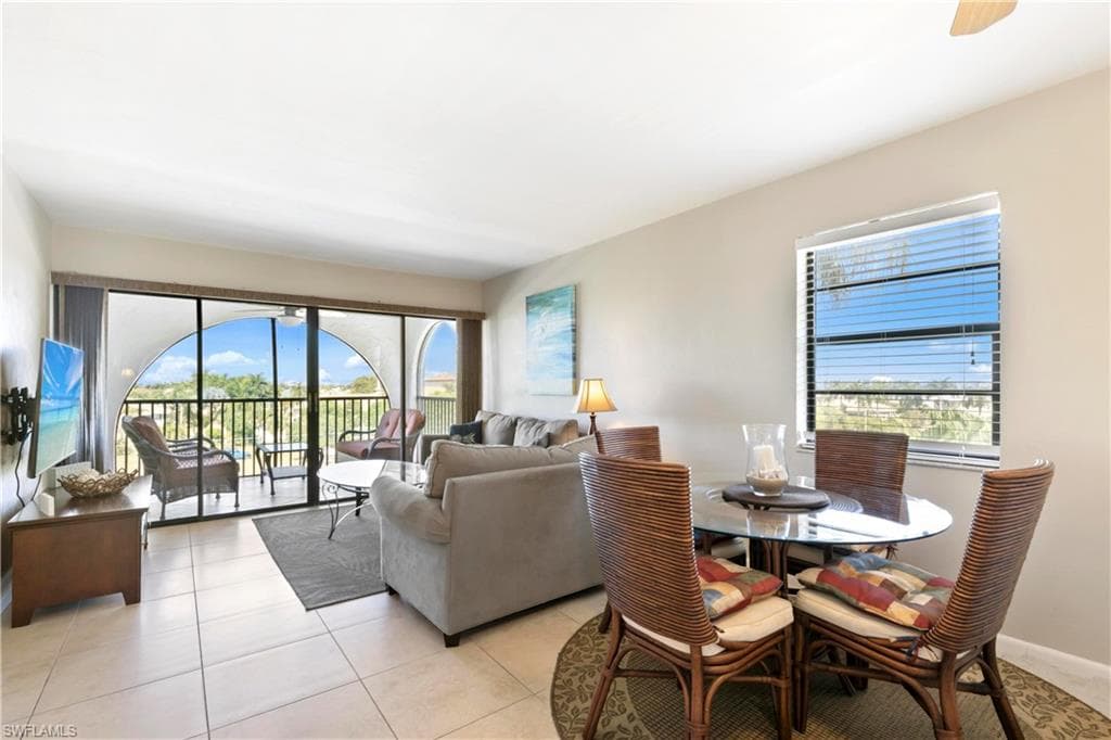 Dining room with a healthy amount of sunlight and light tile floors
