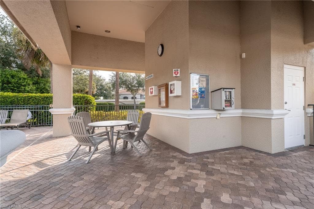 Covered sitting space with bathrooms at the satellite pool.
