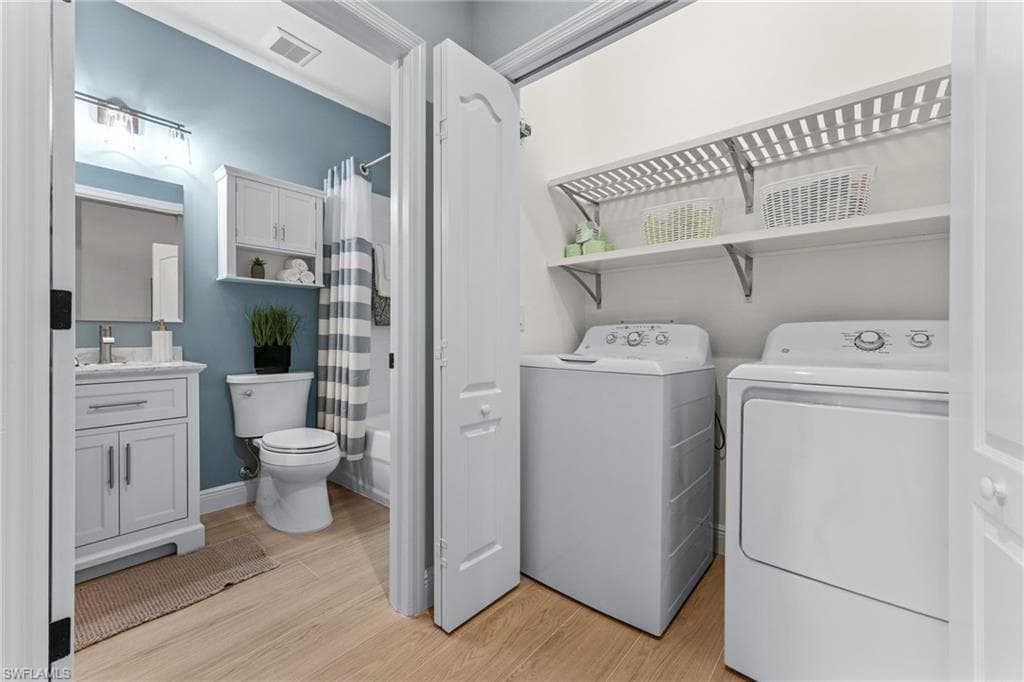 Laundry room. Newer washer and dryer. New wood slat shelves installed for an elevated look.