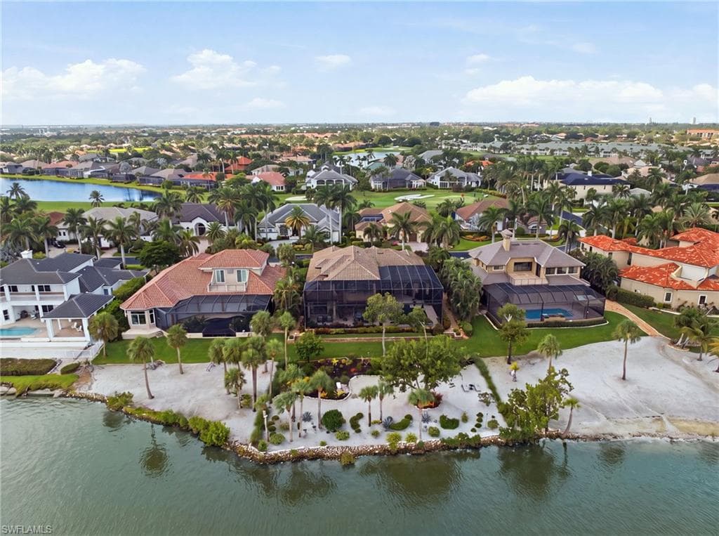 This breathtaking aerial perspective captures the grandeur of the residence and showcases the exquisitely landscaped private beach, revealing the exceptional beauty and thoughtful design of the entire waterfront setting.