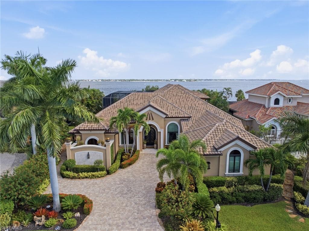 The striking façade was custom conceived by the owner and masterfully brought to life by Jerry Colton of Harbourside Custom Homes, resulting in a truly distinctive architectural statement.