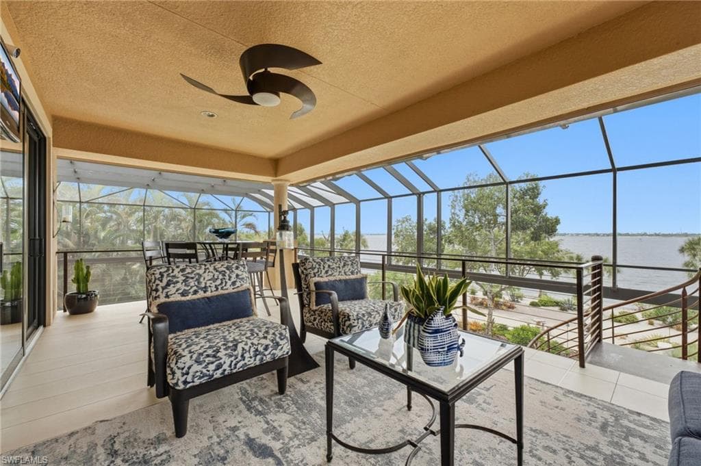 A spacious private balcony extends from the upper level, accessible from the fifth bedroom and theater room, offering an exquisite vantage point for breathtaking Florida sunsets and captivating views of the river and beautifully landscaped beach.