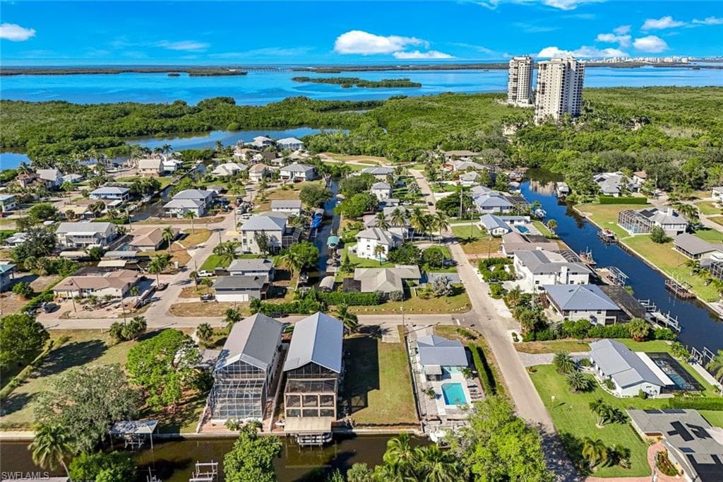 Aerial perspective of suburban area with a nearby body of water