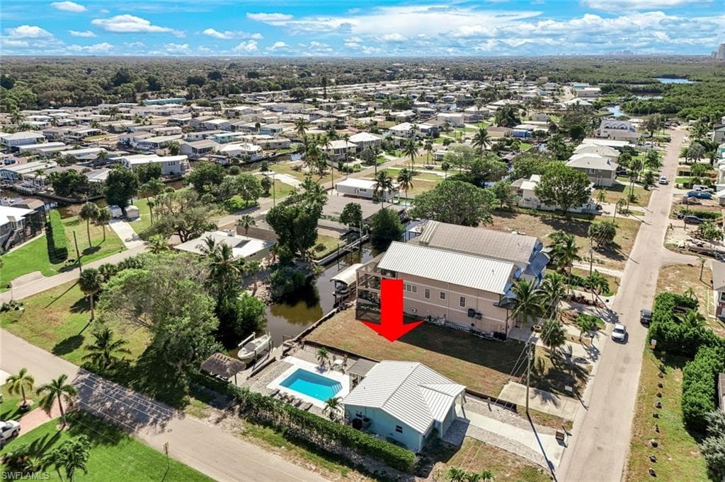 Aerial perspective of suburban area featuring a pool