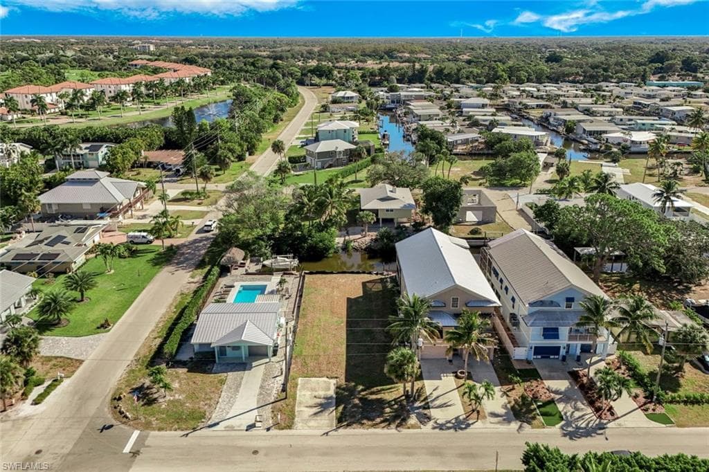 Aerial view of residential area featuring a large body of water
