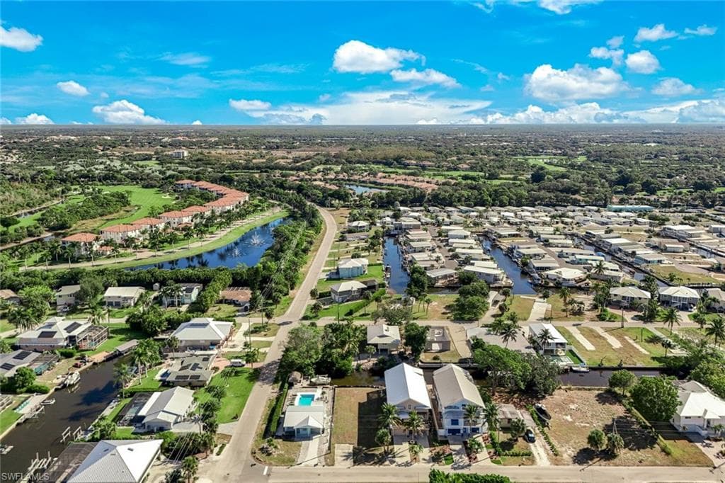 Aerial perspective of suburban area featuring a large body of water