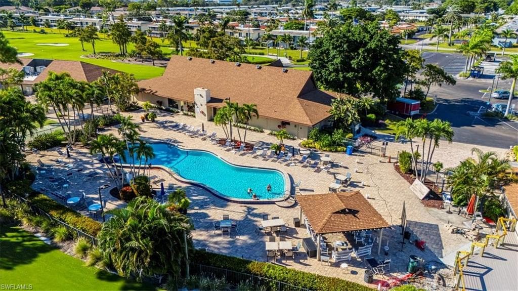 Community pool featuring a patio, a residential view, and golf course view