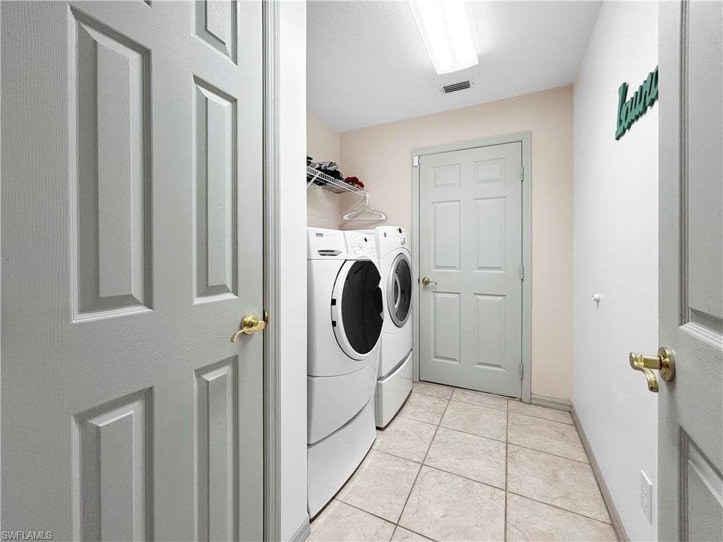 Laundry area with tile flooring and overhead lighting
