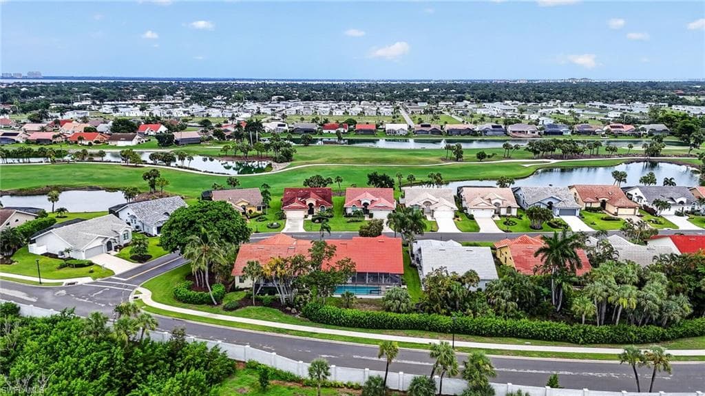Aerial panorama showcasing a residential community with numerous properties featuring varied architectural styles and tiled roofs