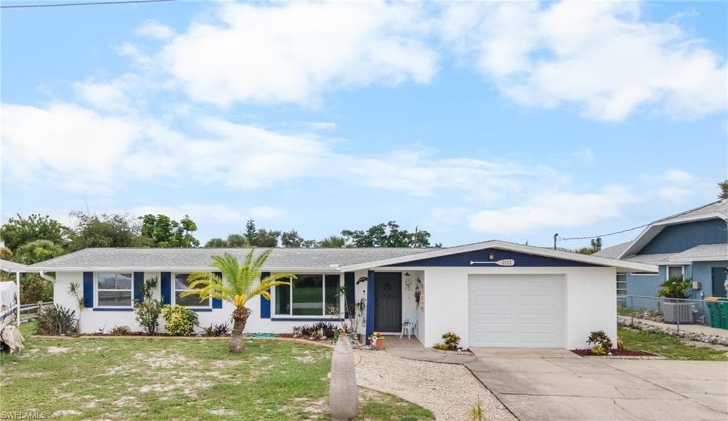 White exterior with blue trim accents and a gray shingle roof