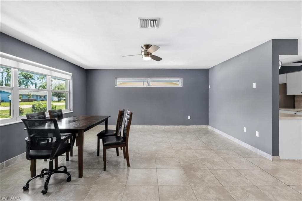 Tile flooring throughout, with a large window and an additional horizontal window