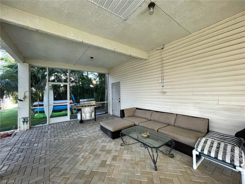 View of patio featuring outdoor furniture and a grill