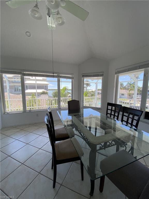 Dining room with lofted ceiling and light tile patterned floors