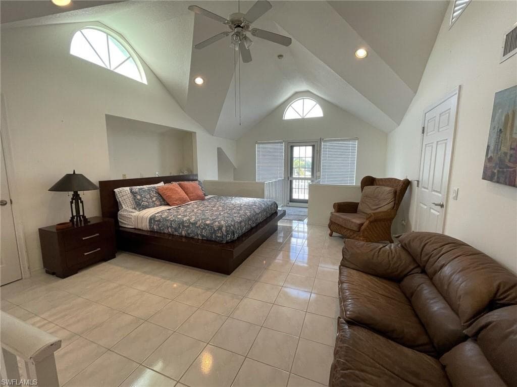 Bedroom featuring recessed lighting, light tile patterned flooring, a ceiling fan, and a high ceiling
