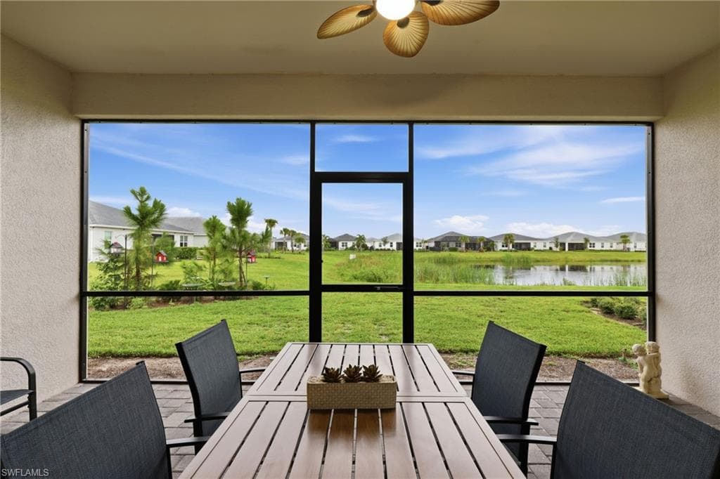 Screened lanai overlooking the backyard and lake, perfect for outdoor dining and relaxing