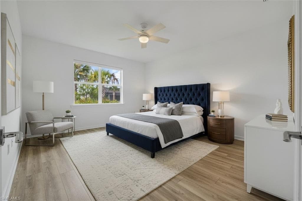 High ceilings, recessed lighting, wood-finish flooring, and a ceiling fan with light fixture