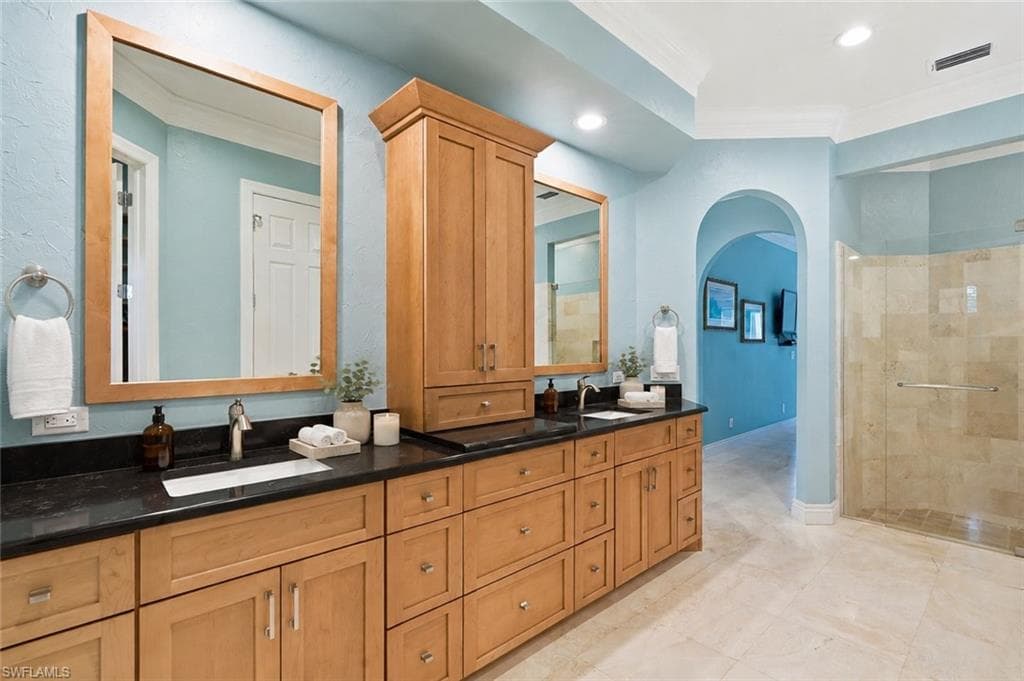 A spacious, spa-inspired bathroom with dual vanities.