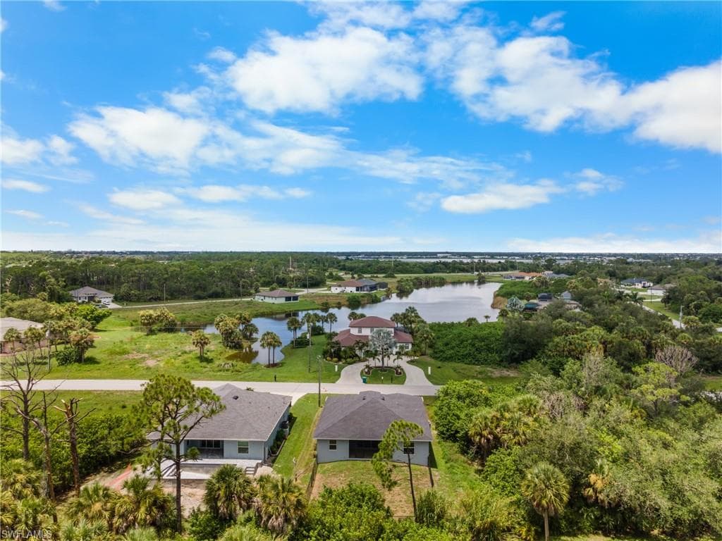 Aerial perspective of a neighborhood featuring a prominent body of water