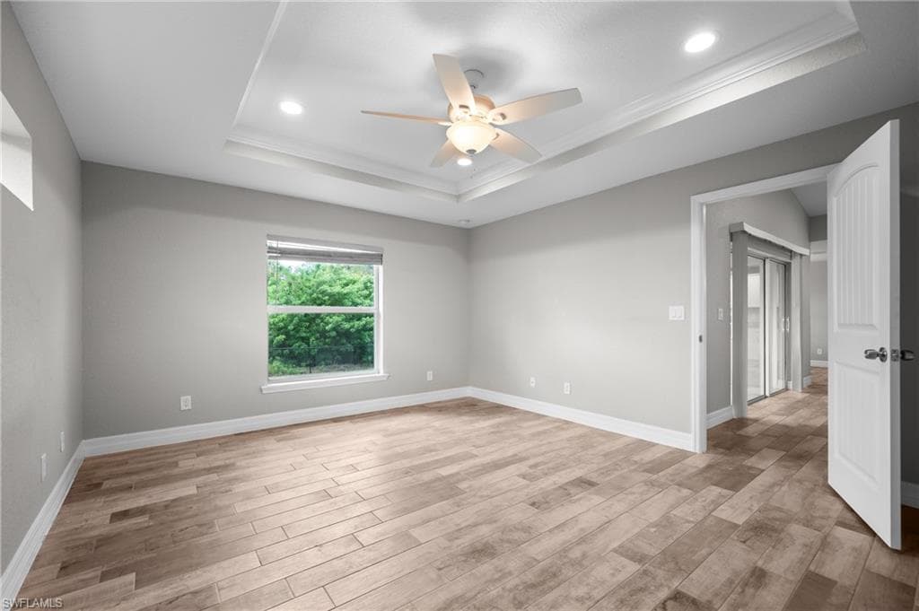 Tray ceiling featuring recessed lighting and crown molding