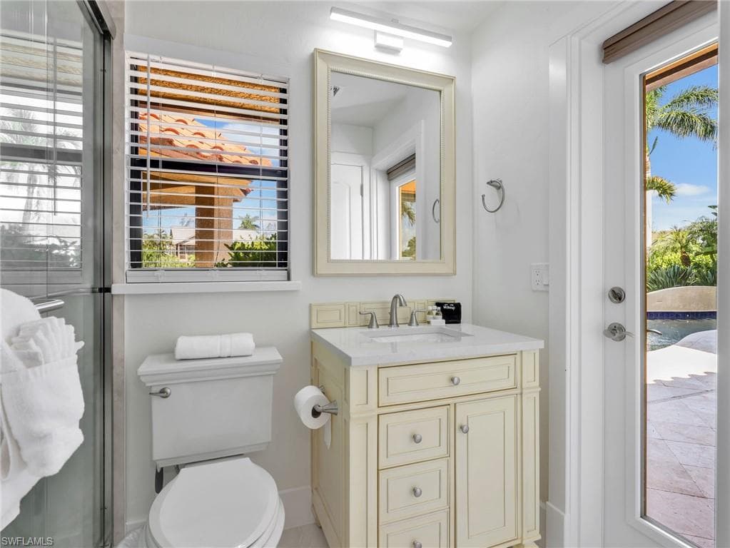 White vanity with an integrated sink and brushed nickel faucet