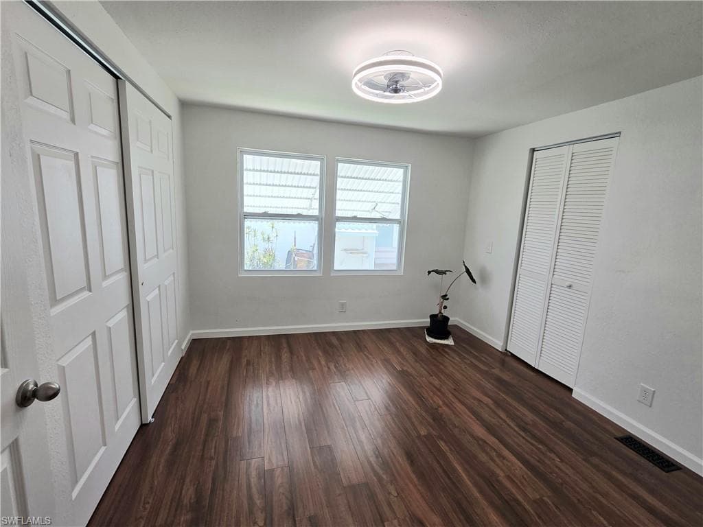 Guest Bedroom with 2 sets of closets, updated light & ceiling fan.