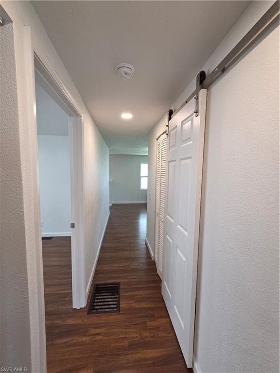 Barn door with stainless track provides privacy to the hall bath.