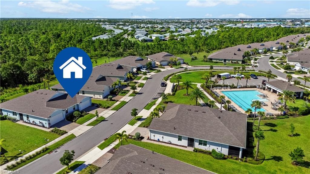 Community with shared swimming pool and recreational area, surrounded by residential properties and natural landscaping