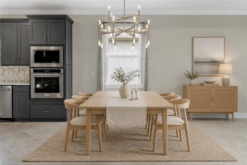 Built-in stainless steel appliances, dark gray cabinetry, light-toned wood-finish flooring, and a modern chandelier