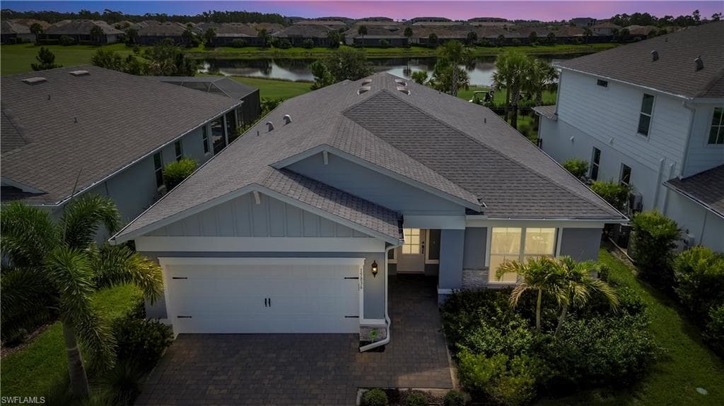 Single-story residence featuring a gray shingle roof, light blue siding, and white trim accents