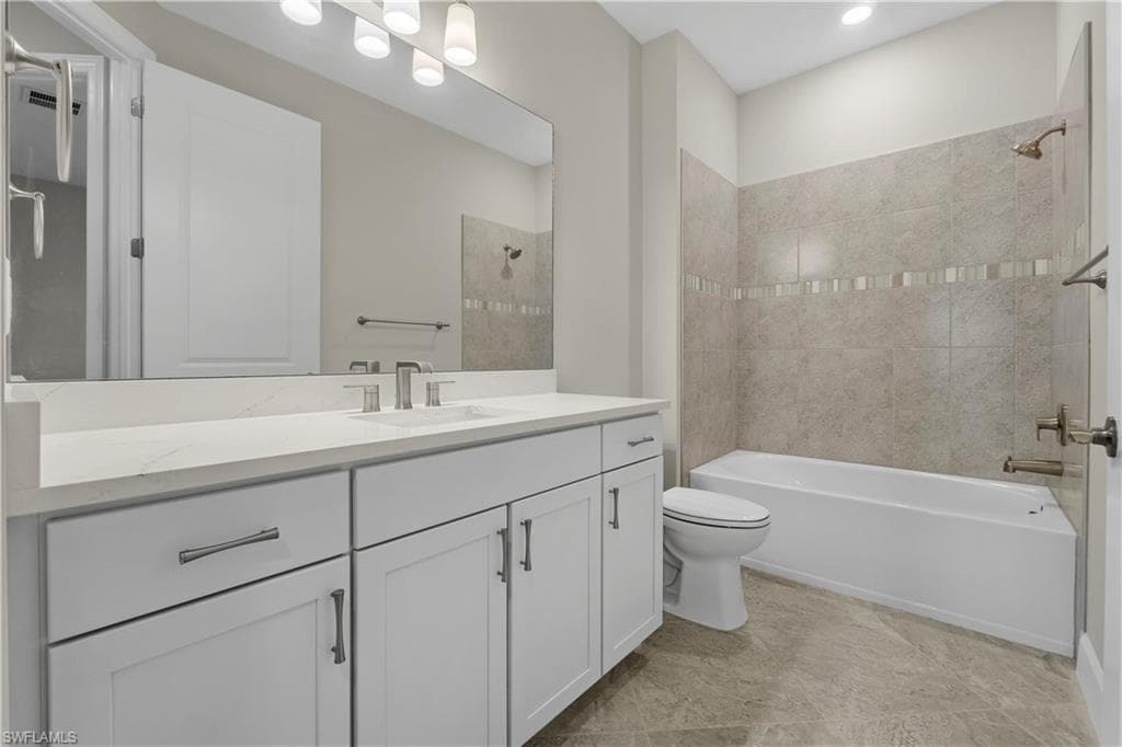 White vanity with brushed nickel hardware, light-toned countertop, rectangular undermount sink, and full-width mirror