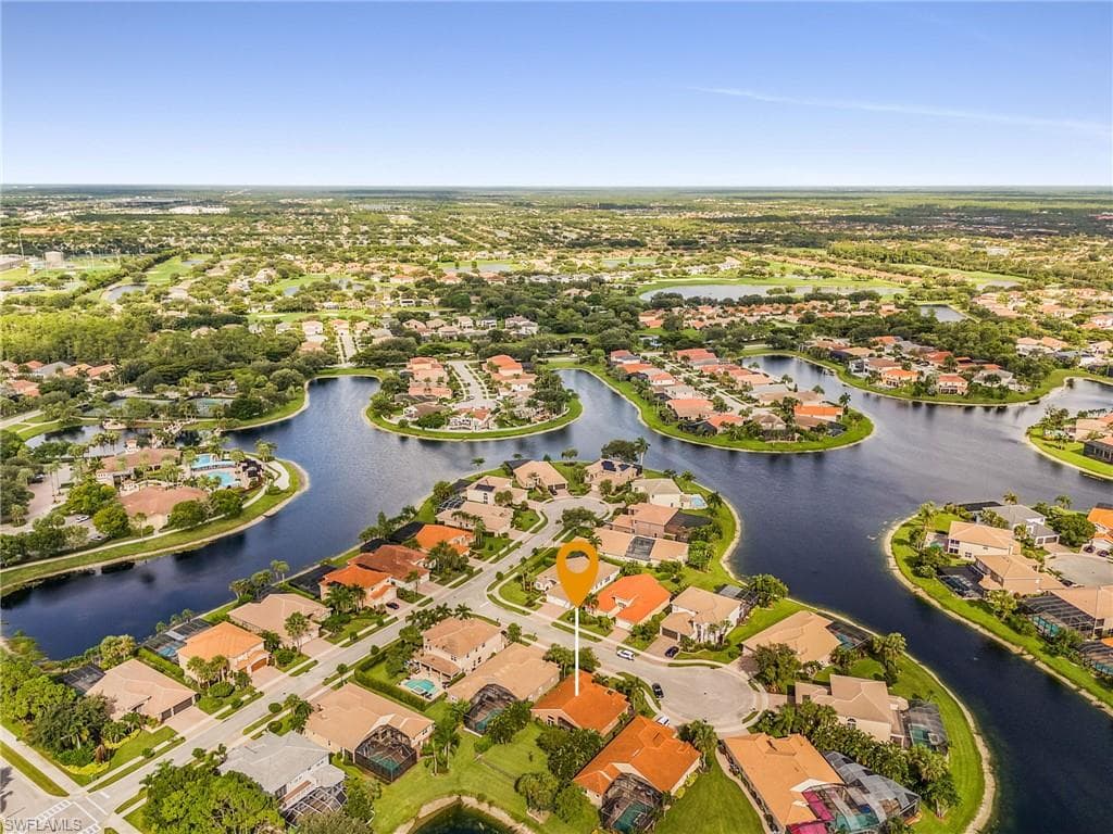 Aerial perspective showcasing a residential community with numerous water features