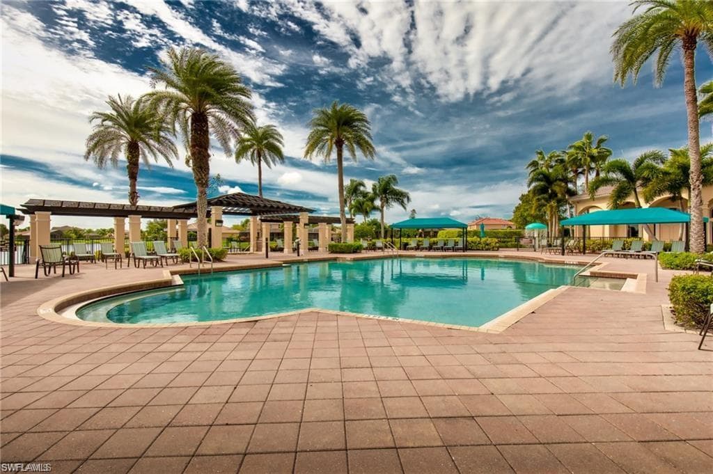 Expansive swimming pool with integrated spa, surrounded by a paver deck