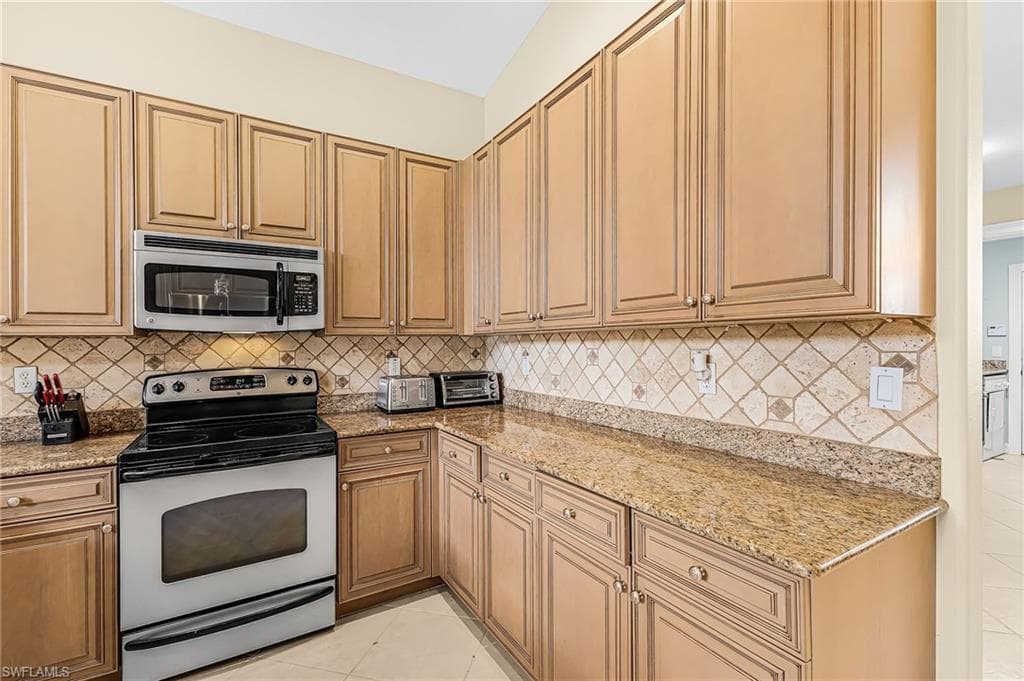 Wood-finish cabinetry paired with a decorative tile backsplash