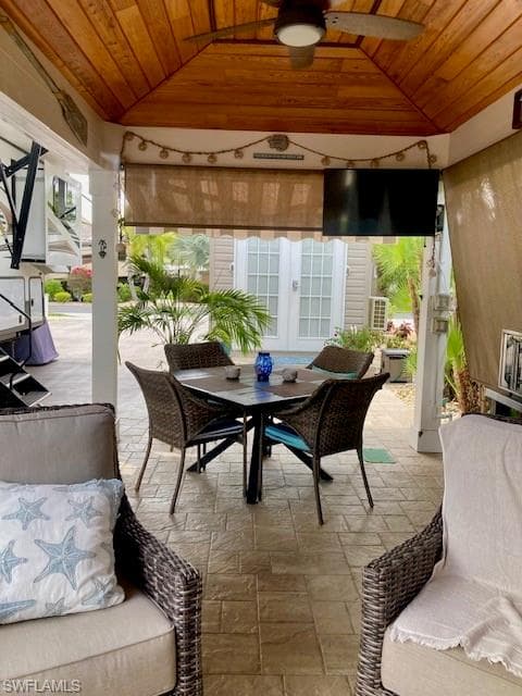 View of patio / terrace featuring french doors, a gazebo, ceiling fan, and outdoor dining space