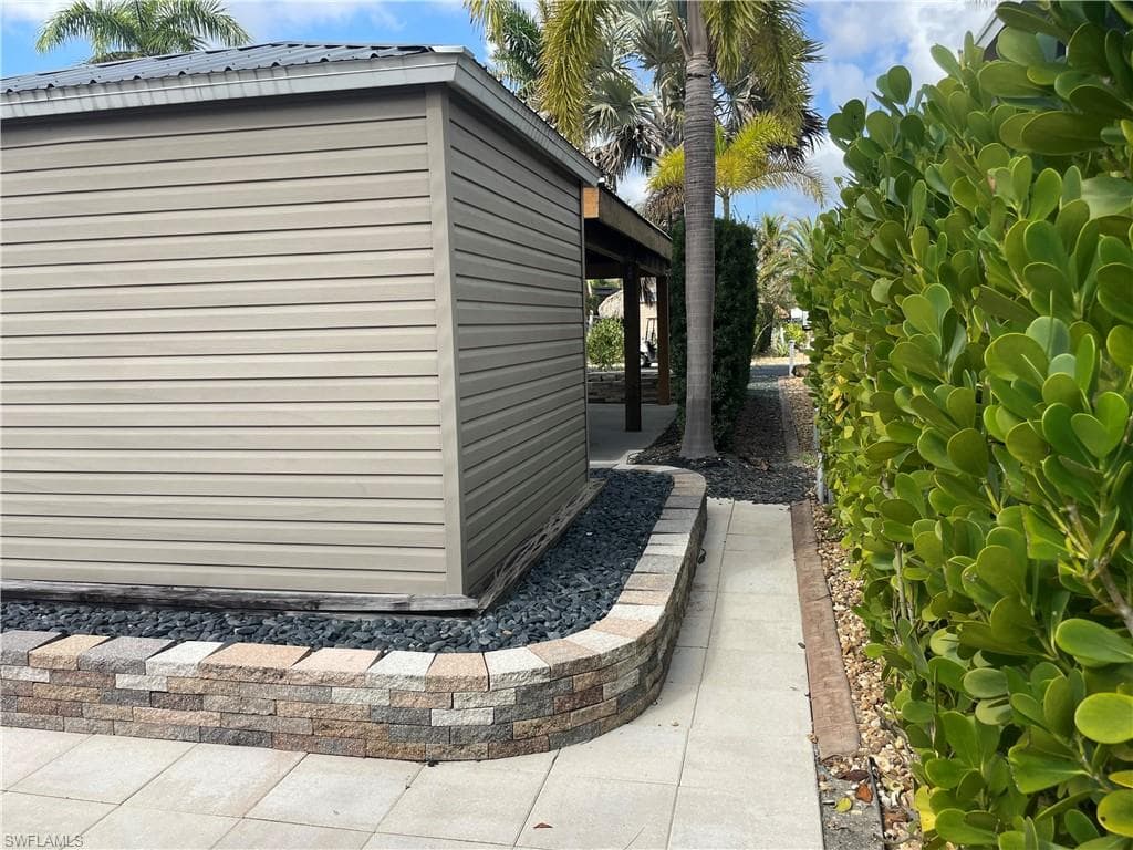 View of property exterior featuring an outbuilding