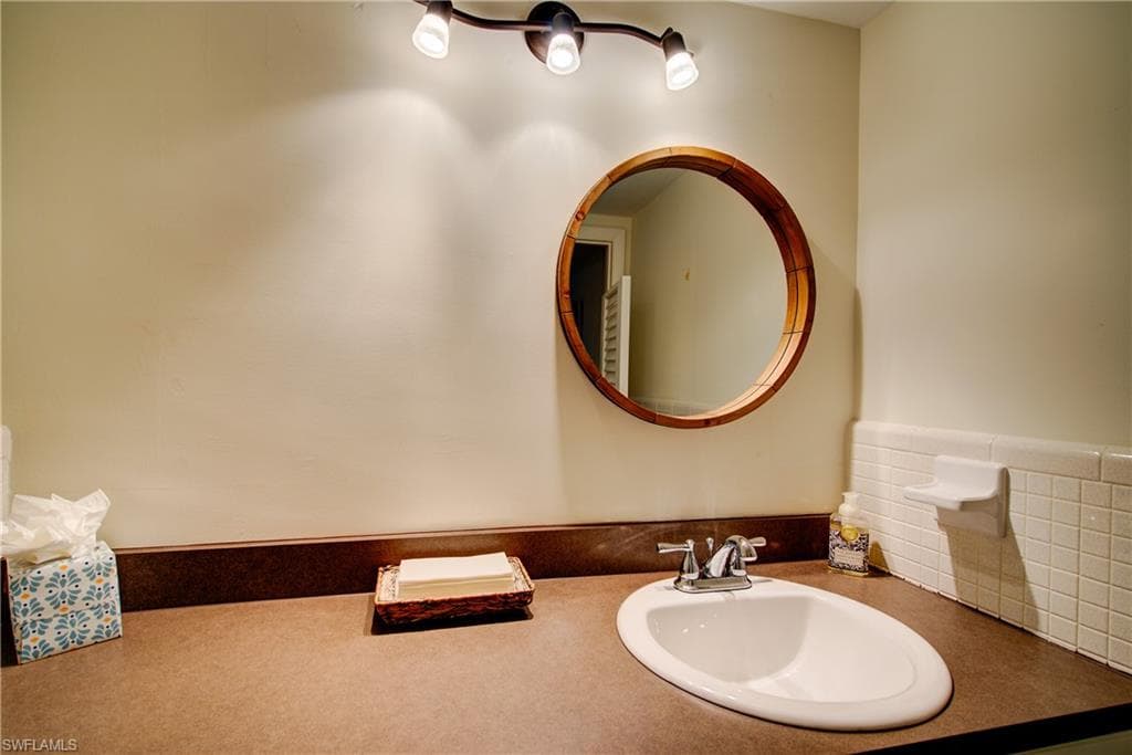 The guest bathroom is a 1/2 bath with a toilet and a sink